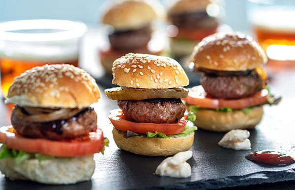 Mini kobe beef sliders with lettuce, tomato and charred onions, served as a late night snack for guests post-wedding reception