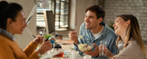 group of people talkin and laughing while eating